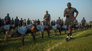 Kenya Police Recruitment 2025 Application Registration Form Portal: Prospective recruits practicing timed runs and push-ups at a field.